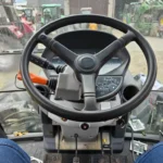 Kubota M135X Cabin, regen button on the left side.